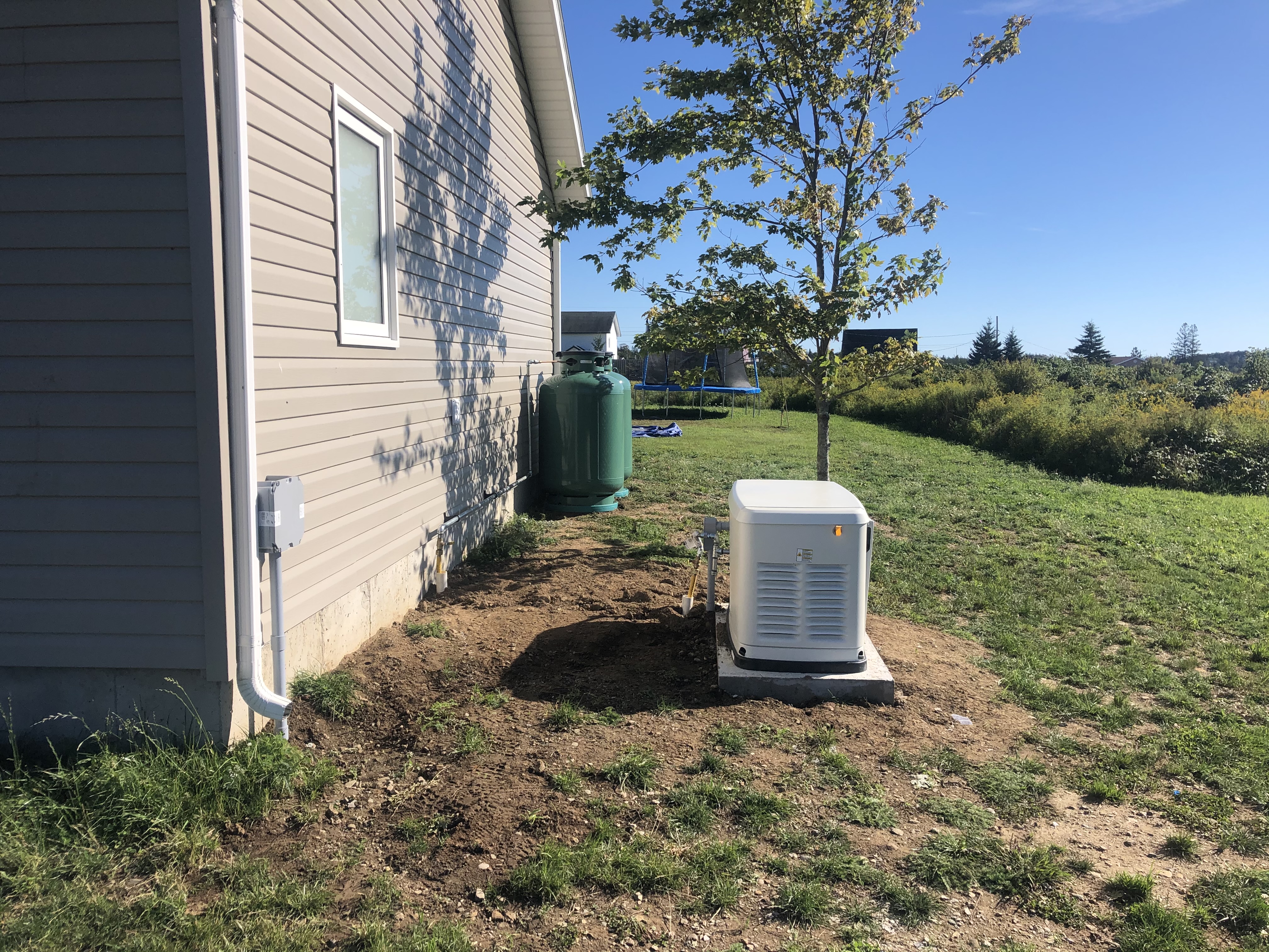 Completed residential standby generator installation providing backup power to a home