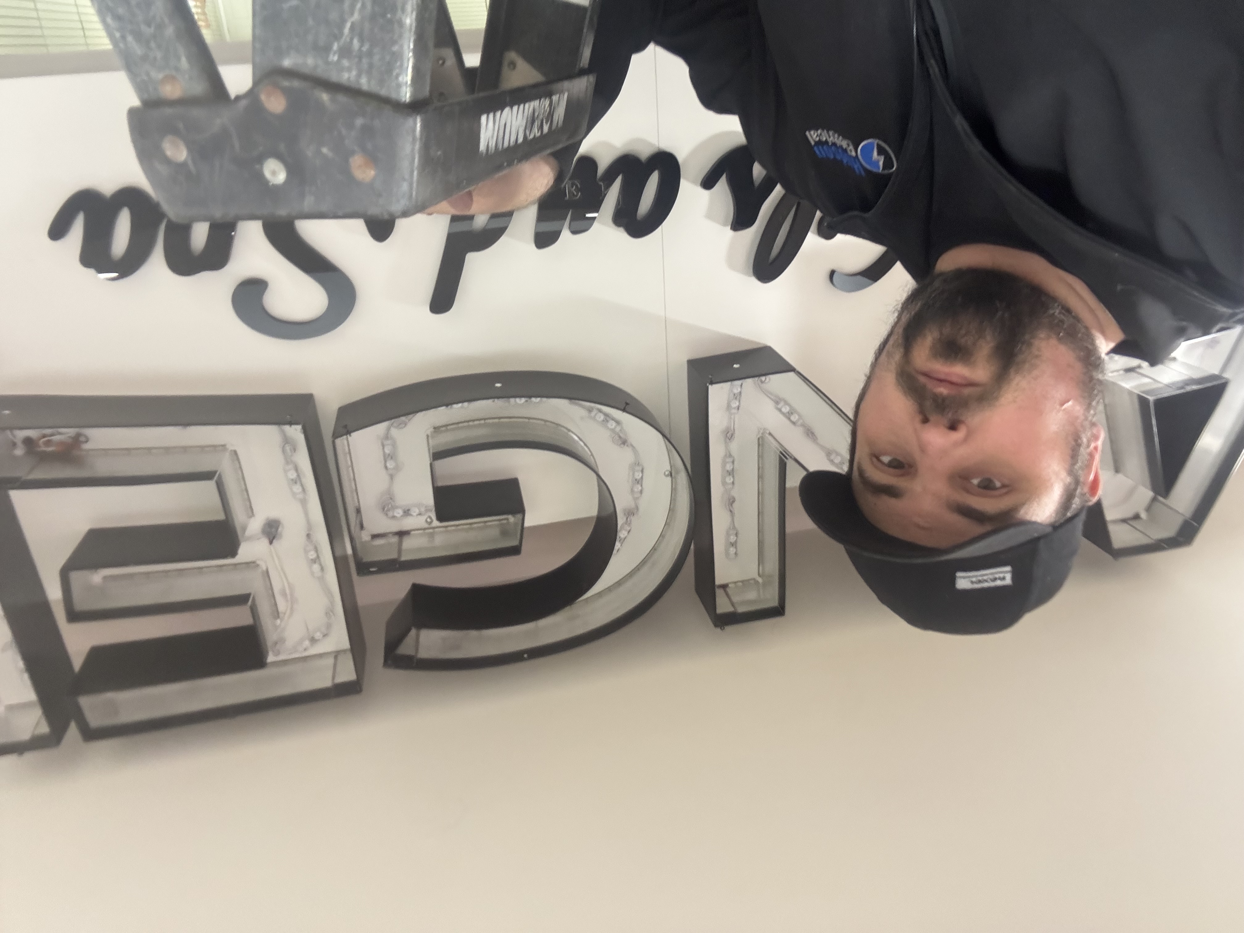 Behind-the-scenes installation of illuminated storefront signage