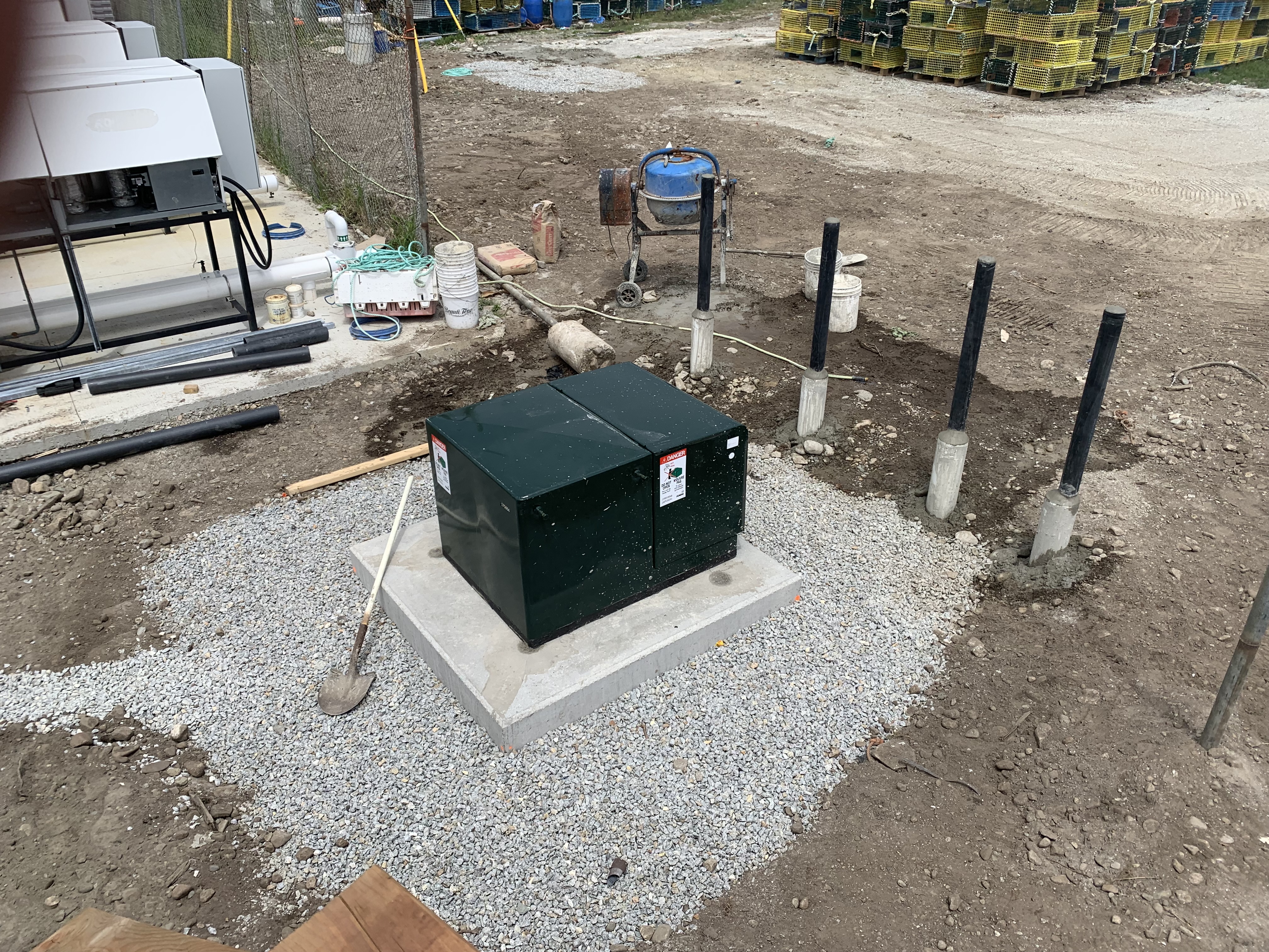 Completed pad-mounted transformer installation with bollards after cable landing for an 800-amp single-phase service
