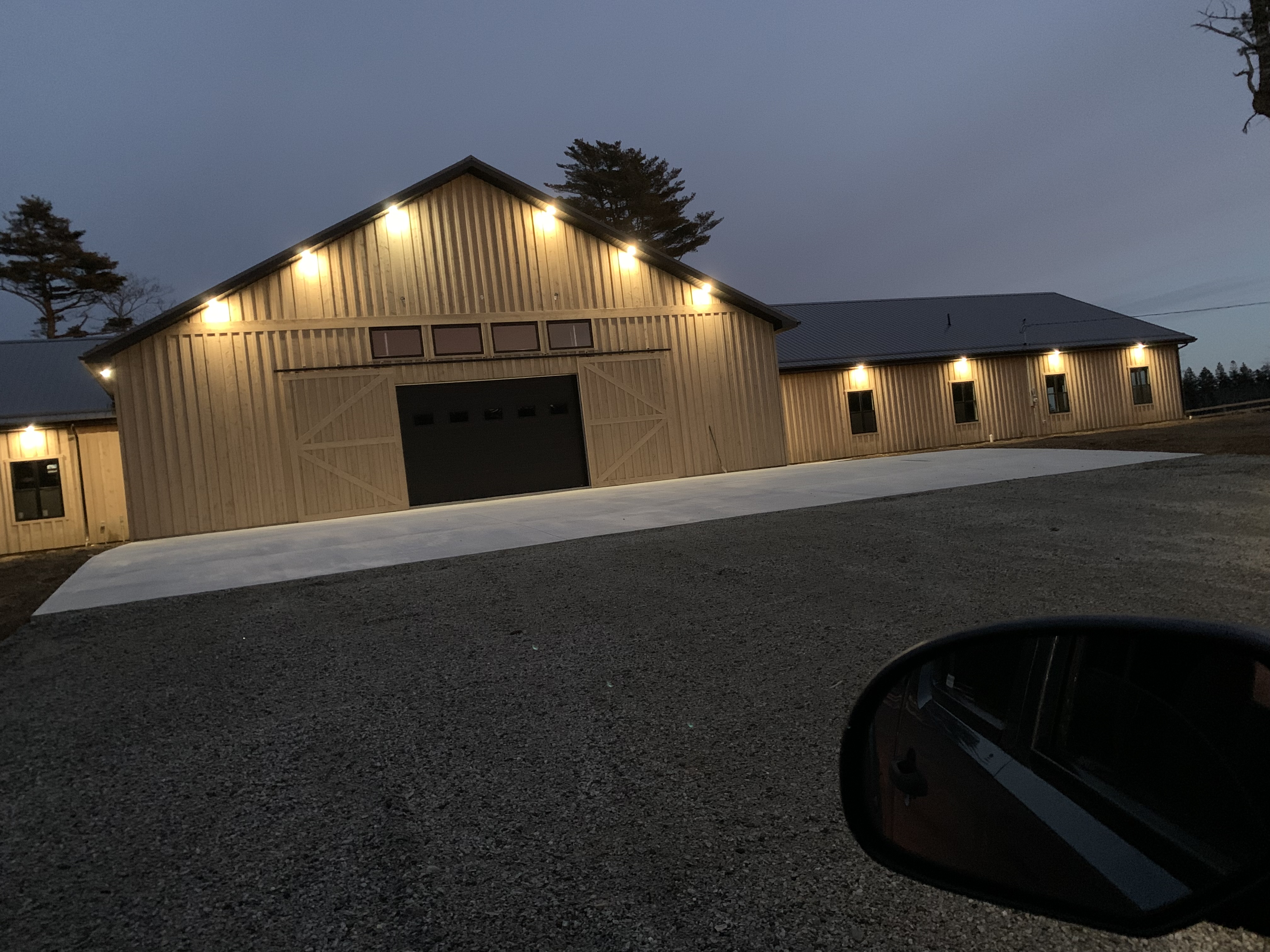 Completed exterior lighting installation at a newly constructed building at dusk